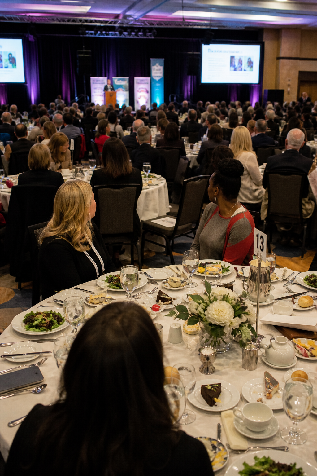 Attendees networking with hors d'oeuvres at a leadership luncheon